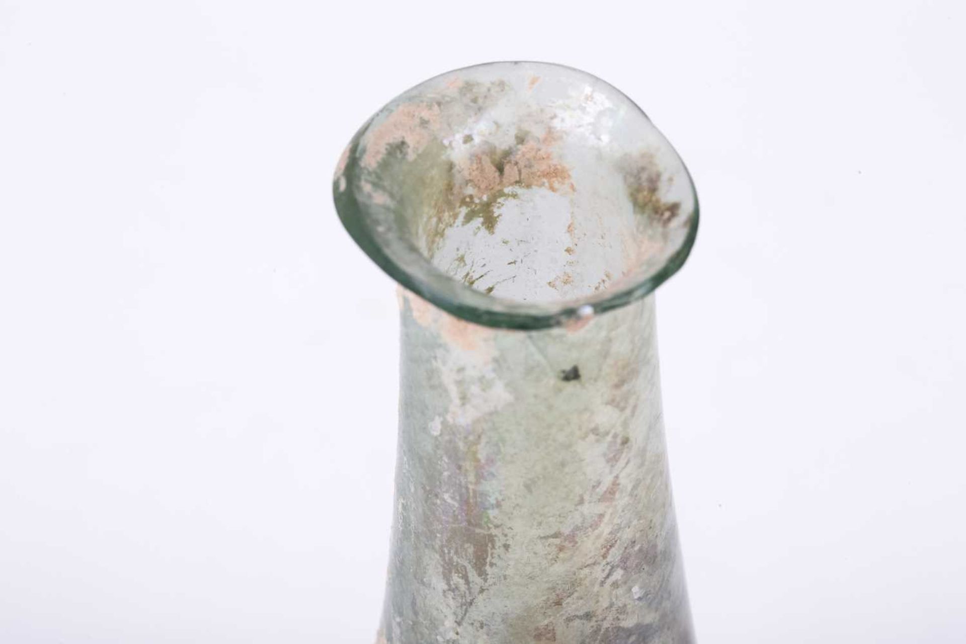 A Roman glass bulbous flask with everted rim, signs of oxidation and encrusted soil to the - Image 3 of 6
