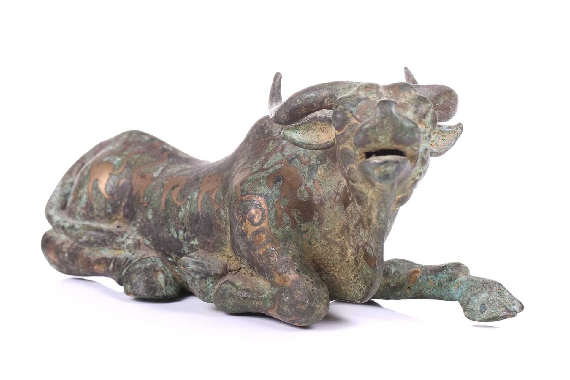 A Chinese bronze and gilt recumbent bull, possibly Zhou dynasty or later, the animal with one leg - Image 6 of 20
