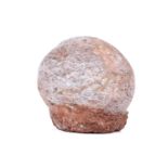A fossilised dinosaur egg, in a red stone base, 14 cm total height, 15 cm wide