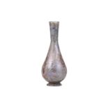 A Roman glass inverted baluster flask with a slightly flared mouth with a band of trailed decoration