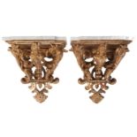 A pair of carved wood and gilt gesso wall brackets with shaped marble tops, late 19th century/ early