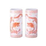 A pair close pair of Chinese porcelain cylindrical sleeve vases, painted with iron red rampaging