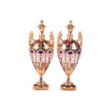 Two matching Royal Crown Derby 'Old Imari' bone china two handled urns and covers, one bearing the