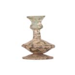 A small glass vase, probably Persia 12th century, of ribbed baluster form, on a flared pedestal