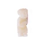 A Chinese white jade figure of a man with curly hair holding a pouch in both hands and carrying an