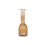 An amber glass beaker, probably Italian 10th century or earlier, of faceted form with the