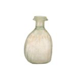 An Italian glass bottle, probably Venetian 10th century, of bulbous form with a ribbed body and