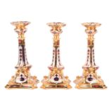 A pair of boxed Royal Crown Derby bone "Old Imari" bone china table candlesticks, bearing the date