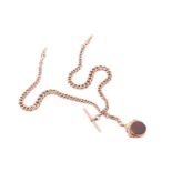 A 9-carat rose gold curb pattern watch chain; of graduated links with single clip terminals and