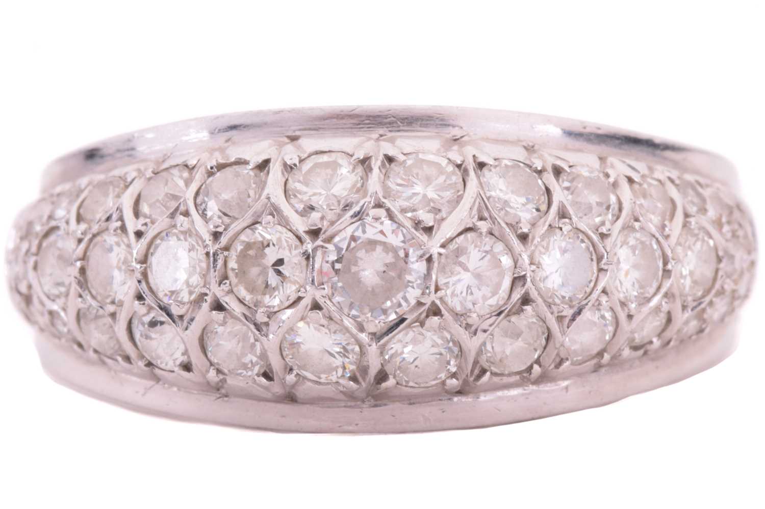 A diamond dress ring, designed as a half hoop set throughout with three rows of round brilliant