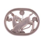 Georg Jensen - a brooch depicting a kneeling fawn and flowers, fitted with a hinged pin stem and