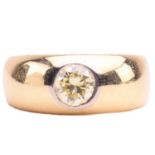A diamond gypsy ring, flush-set with a round brilliant-cut diamond of light yellow colour, with an
