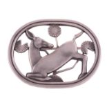 Georg Jensen - a brooch depicting a kneeling fawn and flowers, fitted with hinged pin stem and