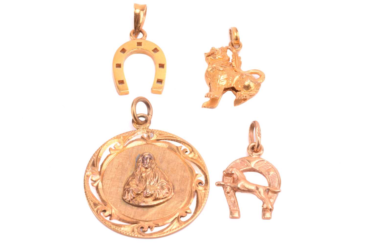 A Chinese pendant with a symbol for prosperity, a Chinese Qilin charm, and two horseshoe charms, all - Image 2 of 2