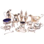 Two silver cream jugs, a silver sauce boat with flying double C scroll handle, a silver salt with