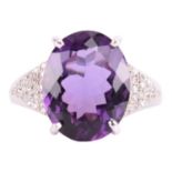 A large amethyst and diamond cocktail ring, featuring an oval-cut amethyst in deep purple colour,