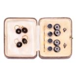 An onyx and diamond dress set comprised of a pair of cufflinks, two dress studs and four buttons, in