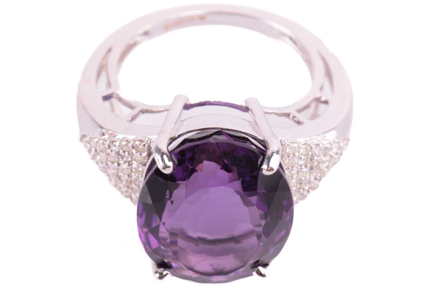 A large amethyst and diamond cocktail ring, featuring an oval-cut amethyst in deep purple colour, - Image 2 of 5