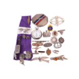 A group of mixed military sweetheart brooches, cap badges and a silver an enamel RAF compact,