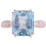 An aquamarine and diamond ring, set with an emerald cut aquamarine to the centre, measuring 12 x