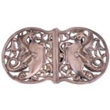 A late Victorian silver nurses buckle by William Hutton & Sons, cast with two dragons each holding a