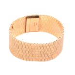 An 18ct gold bracelet circa 1960s, formed of flat textured brick links forming an articulated ribbon