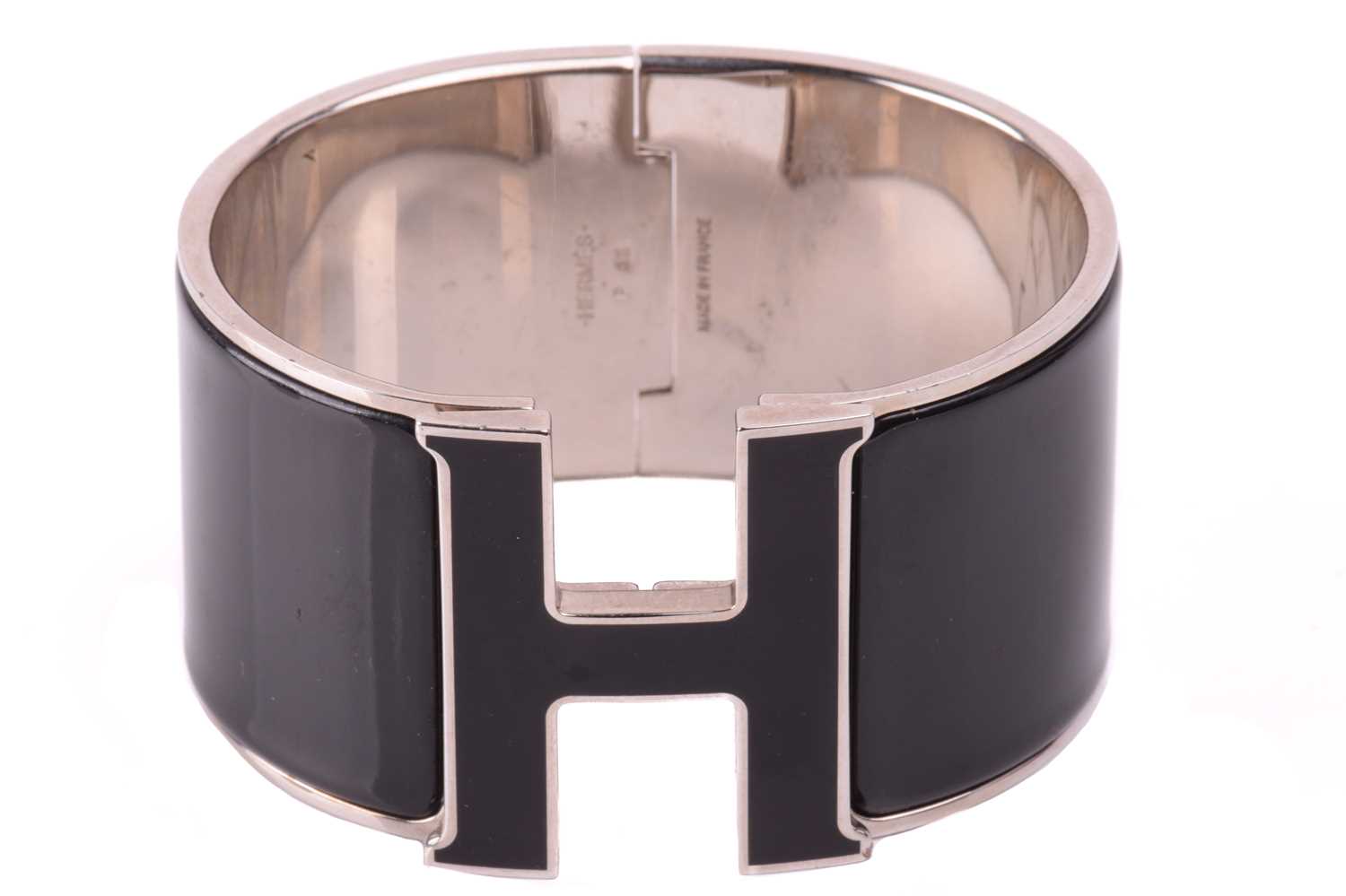 Hermès - an extra wide 'Clic Clac H' bracelet with black enamel and white-toned metal, signed and