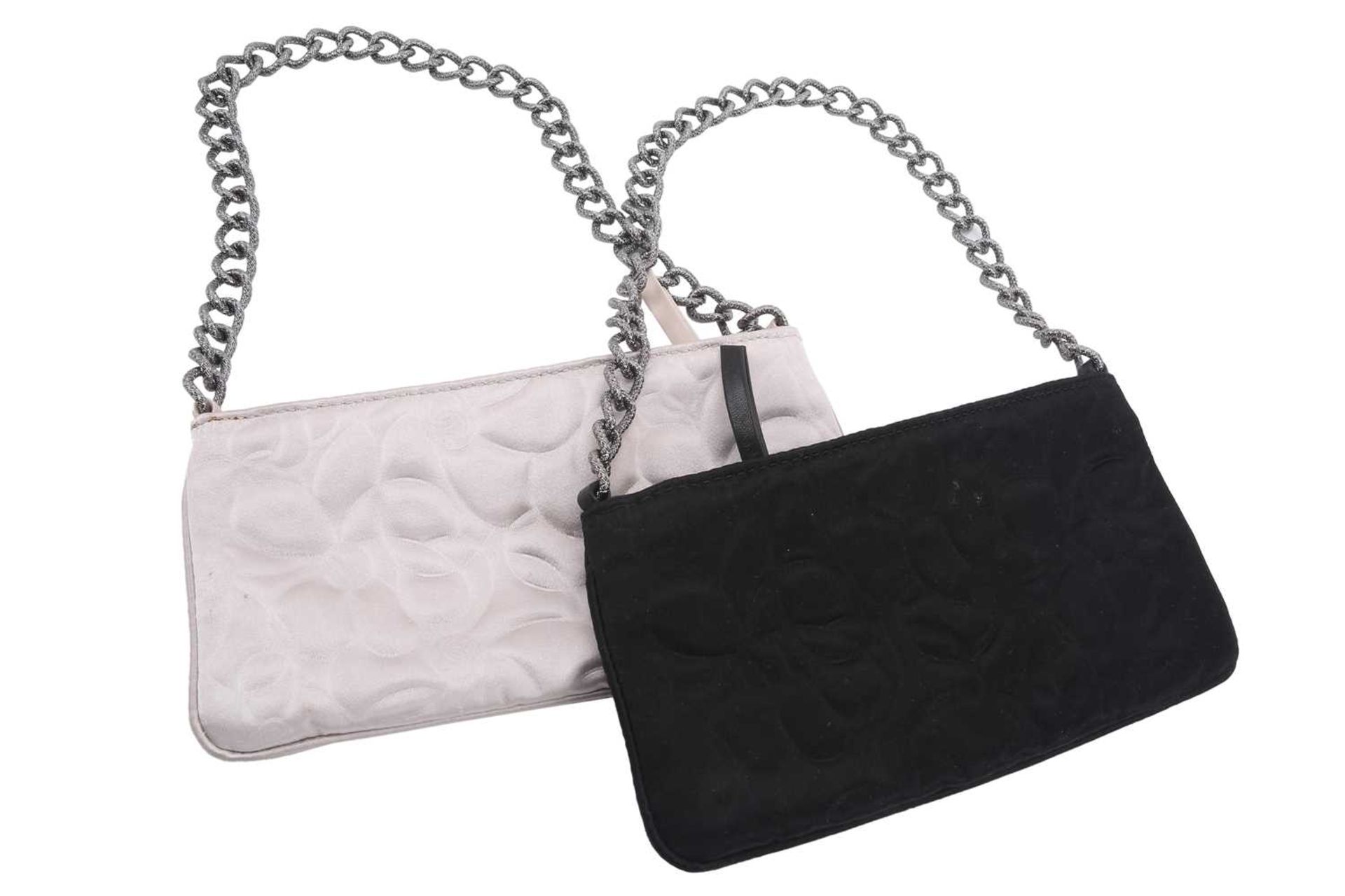Chanel - two satin Camélia Pochettes; designed by Karl Lagerfeld, both black and white evening