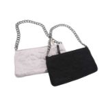 Chanel - two satin Camélia Pochettes; designed by Karl Lagerfeld, both black and white evening