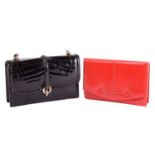 Two leather bags; including a black crocodile skin top handle handbag with gold-tone twist lock, and