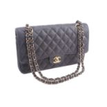 Chanel - a medium classic double flap bag in black diamond-quilted caviar leather, circa 2003,