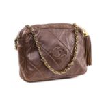 Chanel - a camera bag in brown quilted lambskin leather, circa 1986, the rectangular body with
