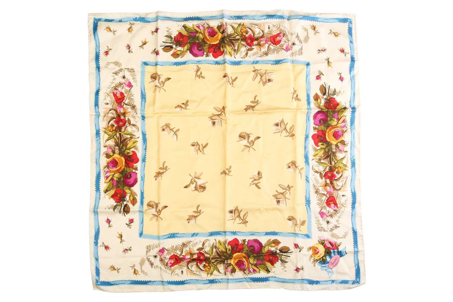 Gucci - a floral silk square scarf in pale yellow, embellished with roses and a light blue border,