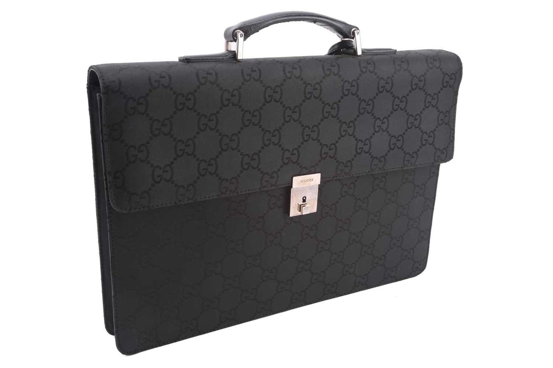 Gucci - a large briefcase in black jacquard nylon with black leather trims, flap fastens with a