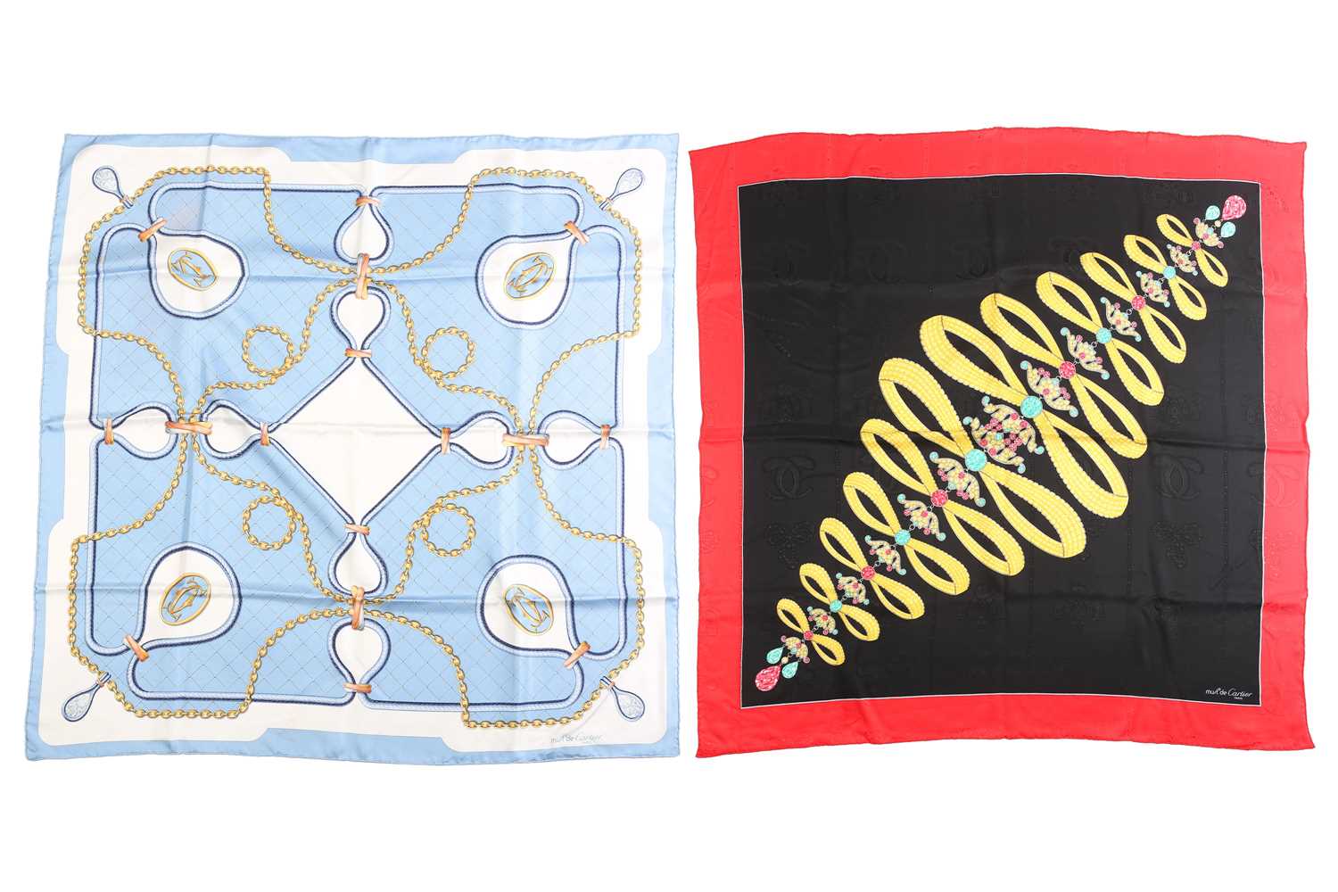 Must De Cartier - two printed silk square scarves; one with jewellery motif on a jacquard black