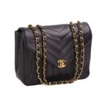 Chanel - a V-stitch flap shoulder bag in black caviar leather, circa 1991, rectangular body with
