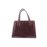 Hermès - a 'Pullman' handbag in brown crocodile skin, circa late 1930, a leather-lined structured