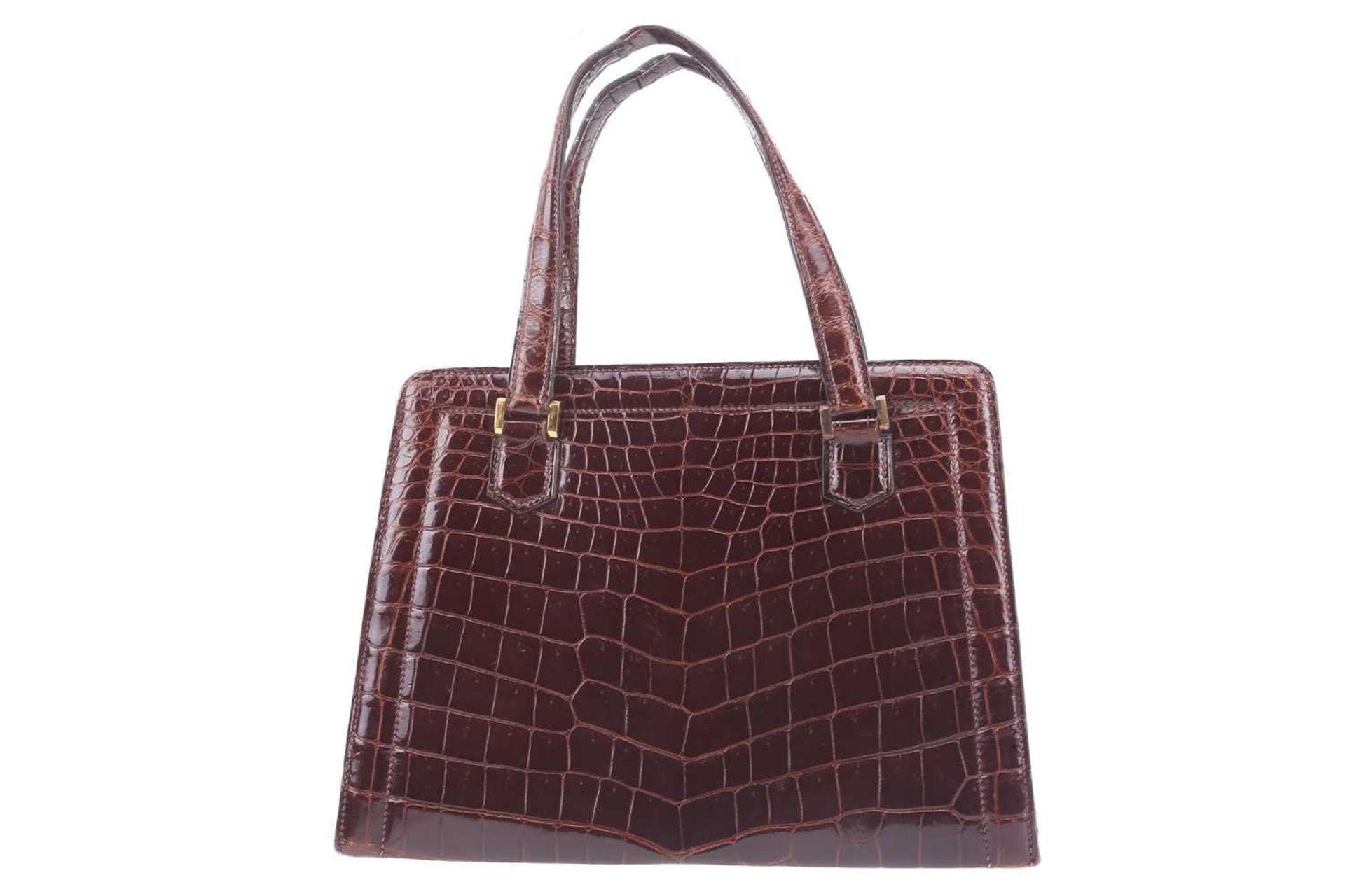 Hermès - a 'Pullman' handbag in brown crocodile skin, circa late 1930, a leather-lined structured