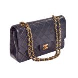 Chanel - a small double flap handbag in black lambskin, circa 1989, diamond-quilt rectangular body