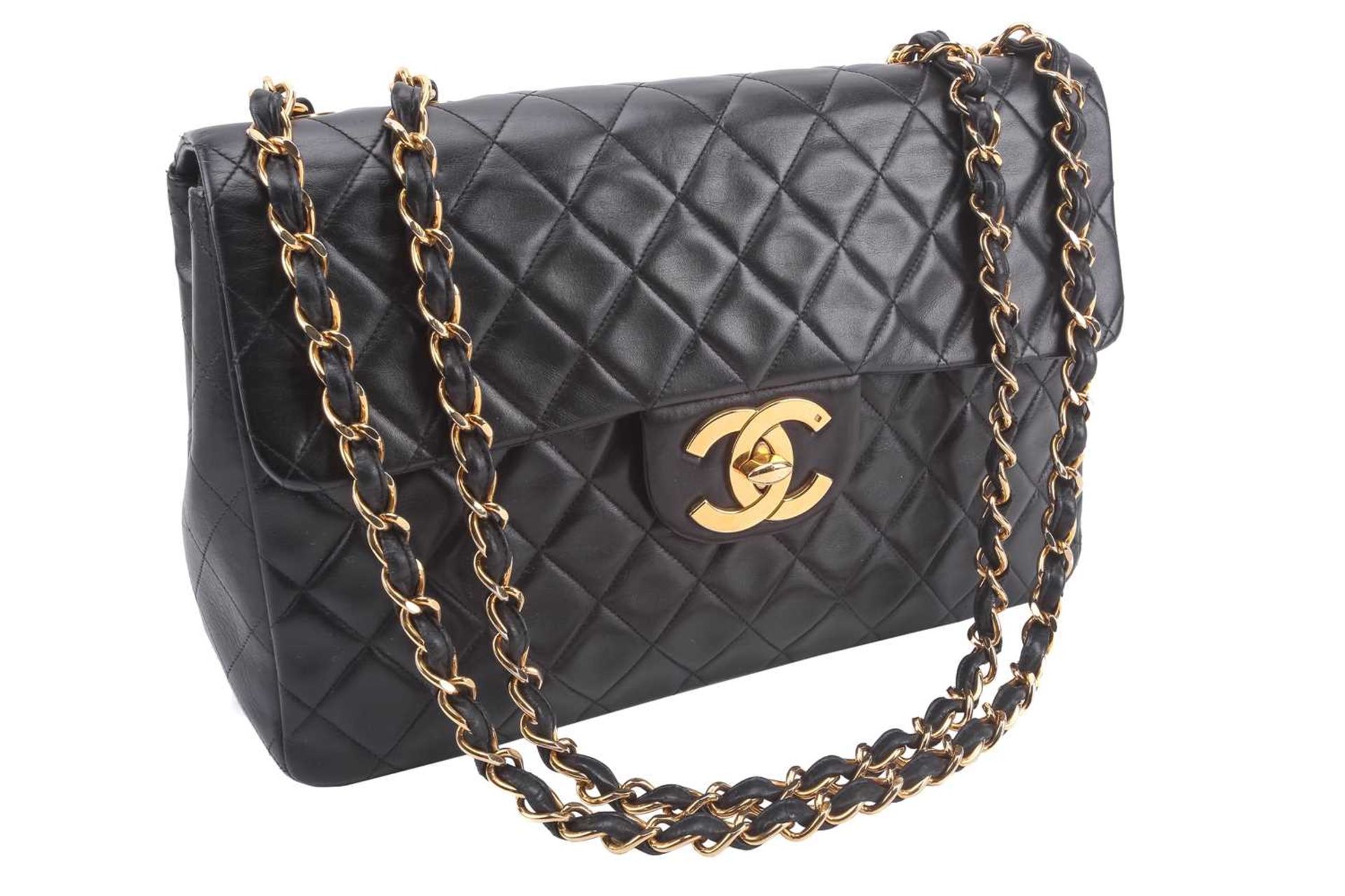 Chanel - a jumbo XL single flap bag in black diamond-quilted lambskin leather, circa 1991,