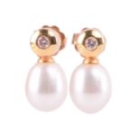 A pair of cultured pearl and diamond earrings in yellow gold, each set with a round brilliant cut