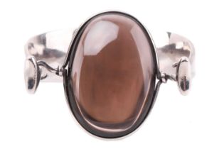 Georg Jensen - 'Arm Ring' with smokey quartz, a tension clamp opening bangle with an oval panel of
