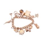 A curb link charm bracelet with hallmarks for 9ct gold, with various charms including a lion,