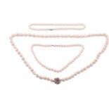 A baroque pearl necklace and two other cultured pearl necklaces; the first comprises a single row of