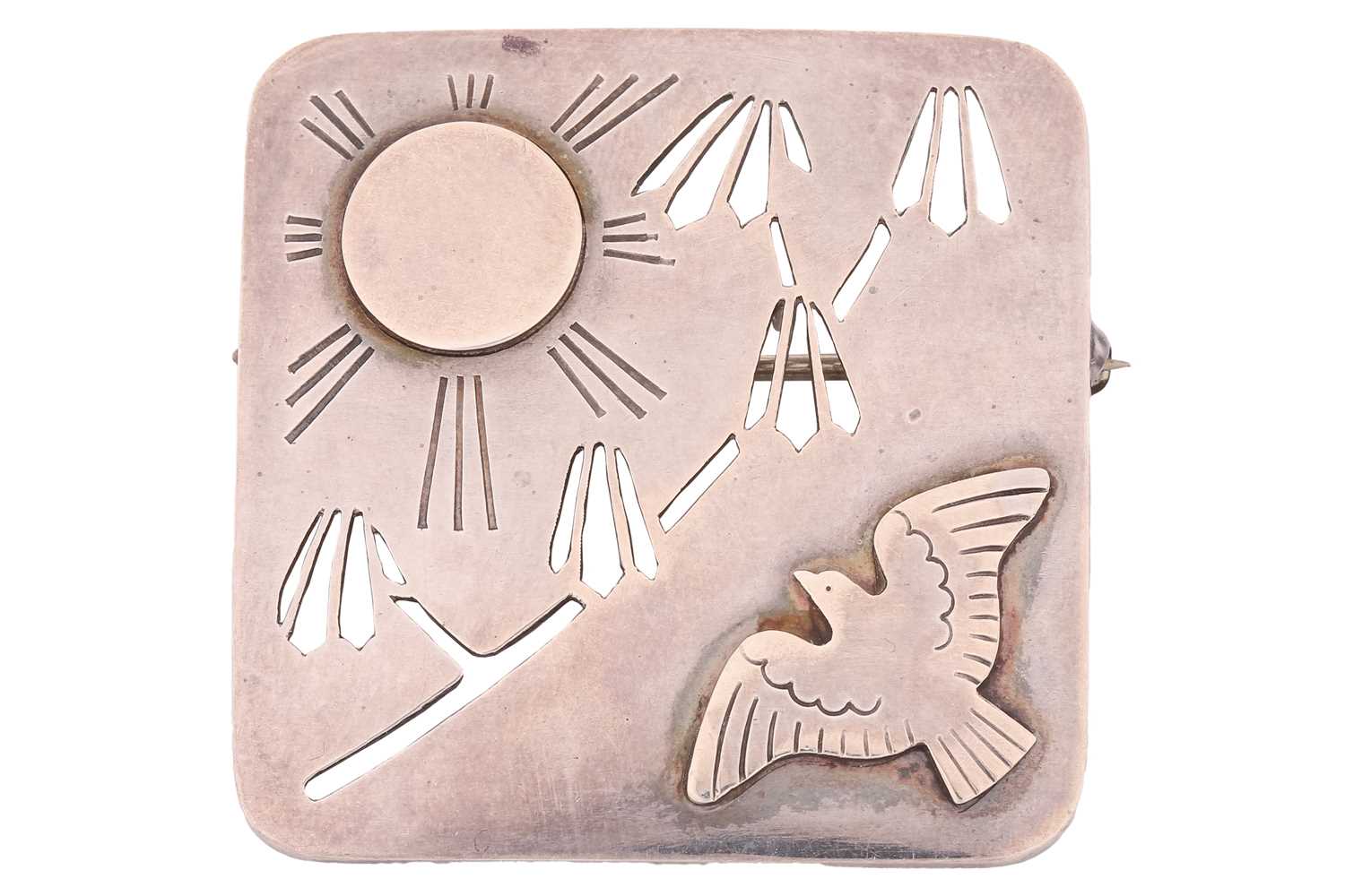 Georg Jensen - a square brooch with rounded corners, decorated in cut card relief with a bird and