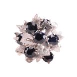 A Modernist cluster ring set with sapphires, of foliate design and geometrical motifs with