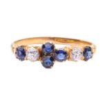 A late Victorian half hoop sapphire and diamond ring; comprising two oval cut sapphires, two old