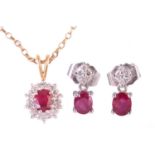 A ruby and diamond cluster pendant, the central ruby measuring 5.7 x 5.2mm, encircled by round