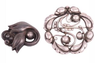 Georg Jensen - a tulip brooch and an openwork foliate brooch; the tulip brooch collet-set with a