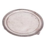 A George III circular silver waiter, London 1817 probably by William Elliot, with gadrooned edge and